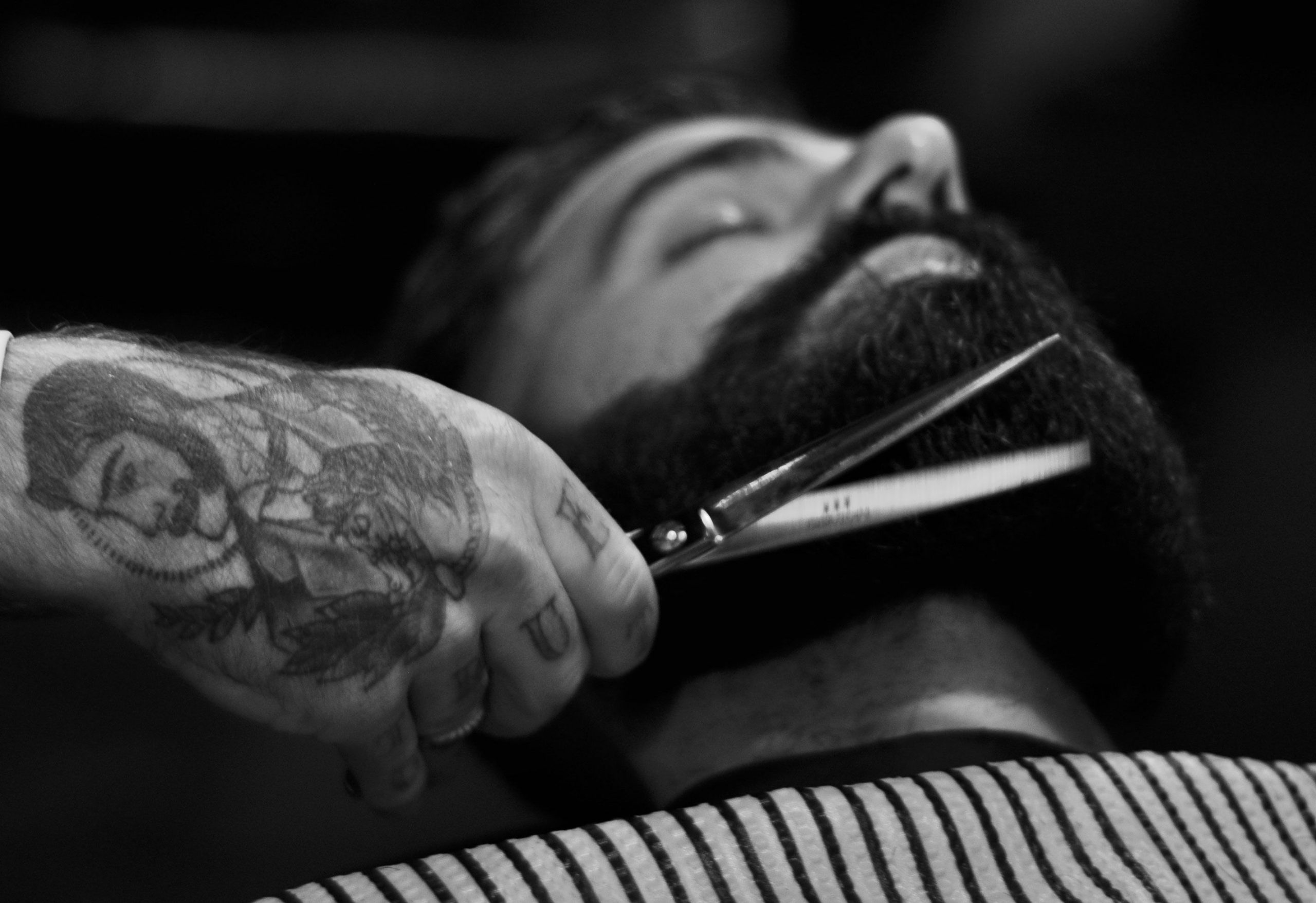 Barber Trimming Client Beard